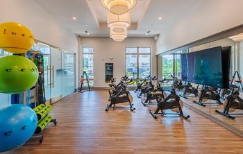 A gym with exercise equipment and a large window.